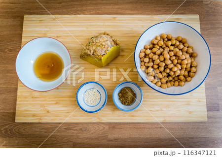 Cutting board with ingredients for preparing chickpea porridge with ginger 116347121