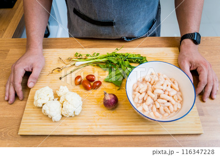 Cutting board with ingredients for preparing bean porridge with cauliflower and vegetables 116347228