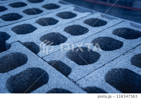 Concrete blocks with holes stacked on top of each other 116347363