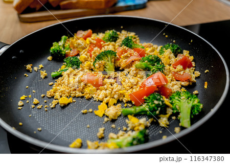 Chef at the kitchen preparing tofu scramble with vegetables Chef at the kitchen preparing tofu scramble with vegetables 116347380