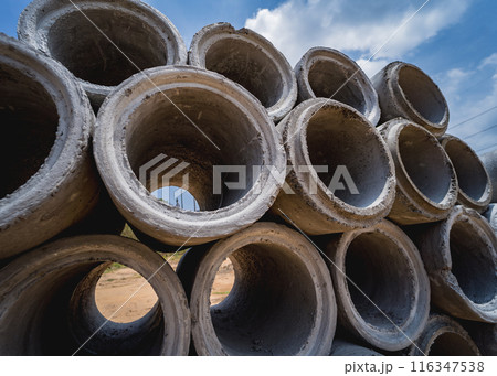 A stack of concrete ring pipes piled and creating a symmetrical arrangement 116347538