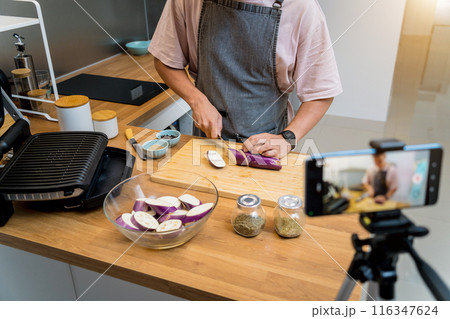 The chef is broadcasting live from workshop how to prepare a grilled eggplants with garlic 116347624