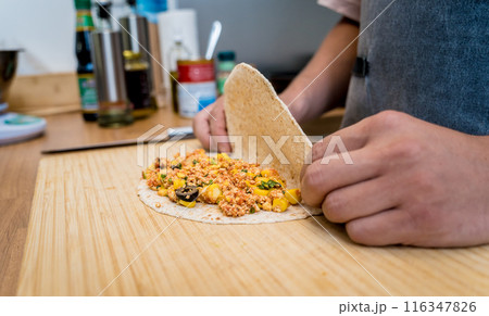 Chef at the kitchen preparing quesadillas with tofu and sweet corn 116347826