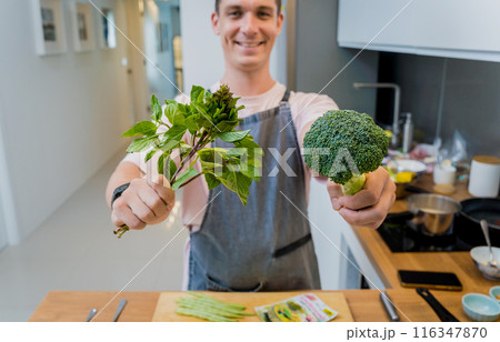 Chef at the kitchen preparing green curry with herbs and rice Chef at the kitchen preparing green curry with herbs and rice 116347870