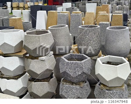 Several concrete plant pots are stacked on top of each other 116347948