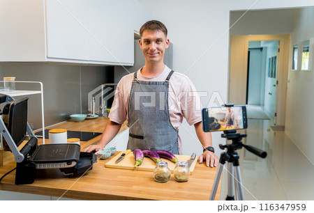 The chef is broadcasting live from workshop how to prepare a grilled eggplants with garlic 116347959