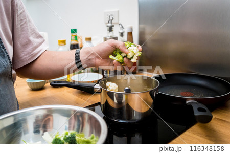 Chef at the kitchen preparing lentils soup with cauliflower and broccoli Chef at the kitchen preparing lentils soup with cauliflower and broccoli 116348158