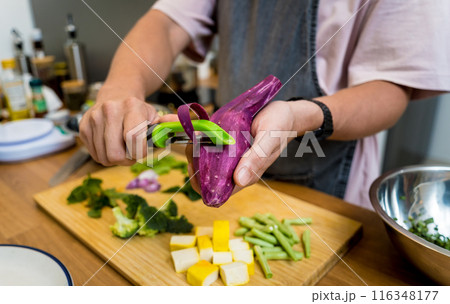 Chef at the kitchen preparing green curry with herbs and rice Chef at the kitchen preparing green curry with herbs and rice 116348177