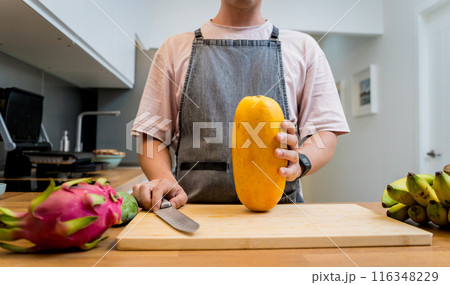 Chef cuts and peels papaya on the cutting board 116348229