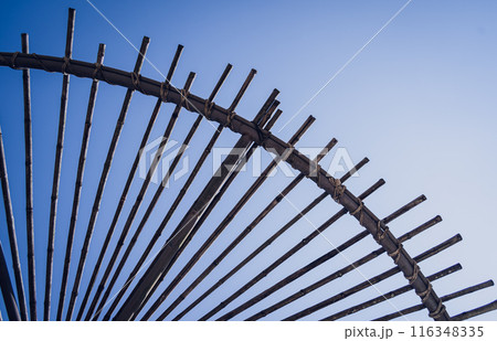 A wooden canopy against the backdrop of a clear blue sky 116348335