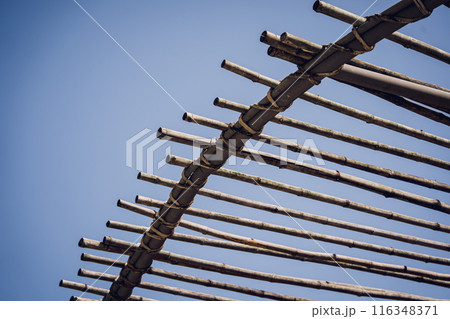 A wooden canopy against the backdrop of a clear blue sky A wooden canopy against the backdrop of a clear blue sky 116348371