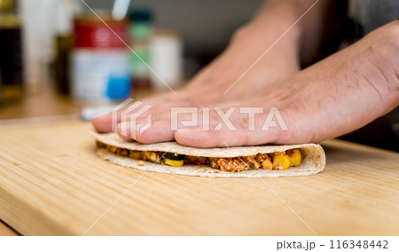 Chef at the kitchen preparing quesadillas with tofu and sweet corn 116348442