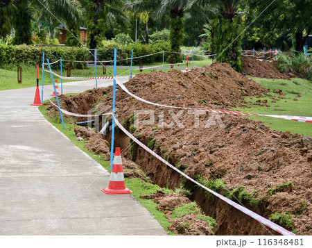 There is a significant heap of soil beside the road 116348481