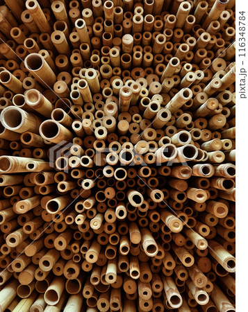 Background of bamboo tubes are arranged in a stack on top of one another 116348784