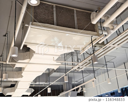 Ceiling with ventilation pipes and lights in industrial building 116348833