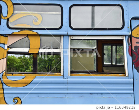 A blue bus with a cartoon character painted on its surface 116349218