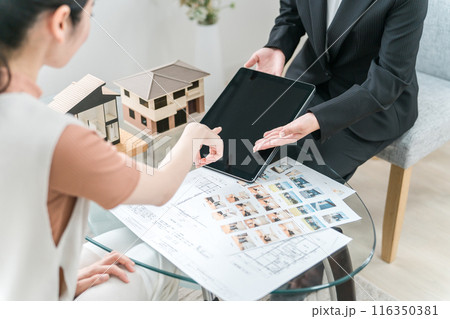 タブレット・設計図・図面を見ながらマイホームのリフォームを提案をするビジネスウーマンの手元 タブレット・設計図・図面を見ながらマイホームのリフォームを提案をするビジネスウーマンの手元 116350381