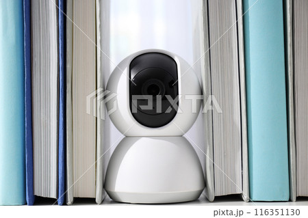 White surveillance camera on a light background 116351130