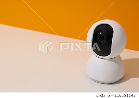 White surveillance camera on a light background 116351145