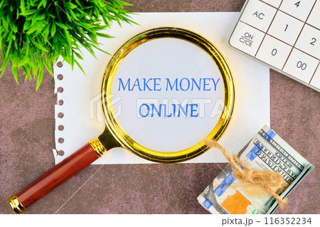 Make Money Online symbol. Concept words Make Money Online through a magnifying glass in a composition with American dollars, a calculator and a plant 116352234