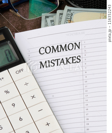 Conceptual symbol. Common mistakes text written in the business book notebook next to the calculator. Vertical photo 116352243
