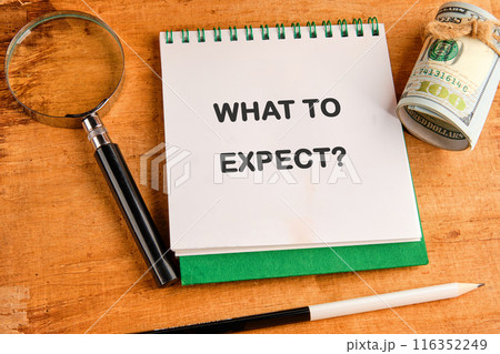 What to expect text in a notebook in a composition with a magnifying glass, dollars and a pencil 116352249