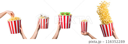 Woman hand taking popcorn from striped bucket isolated on white background 116352289