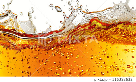 Close-up of beer bubbles and foam in a refreshing amber liquid 116352632