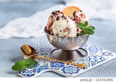 Chocolate and vanilla ice cream in a metal bowl. 116352996