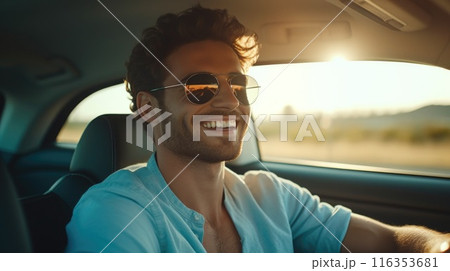 Driving charm charisma: a handsome man behind the wheel of his car - showcasing the sophistication and allure of a man at the helm of his vehicle, exuding poise and power on the open road. 116353681