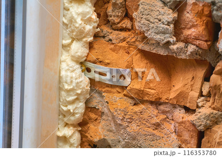 Construction foam. Installation of a metal plastic window,door,brick wall. Construction foam. Installation of a metal plastic window,door,brick wall. 116353780