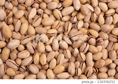 background of unpeeled almond nuts, close up 116356252