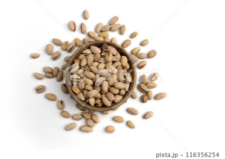 wooden bowl of unpeeled pistachio isolated on white 116356254