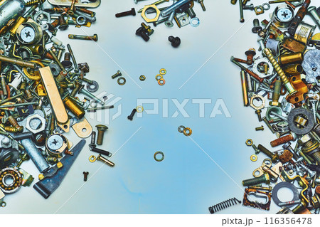 Iron small metal trash on blue.Lots of different nuts, bolts, washers 116356478