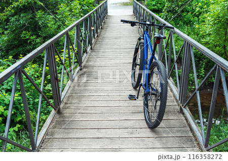 Blue mountain bicycle parked on the bridge. Cycling and an active healthy lifestyle background. 116358272