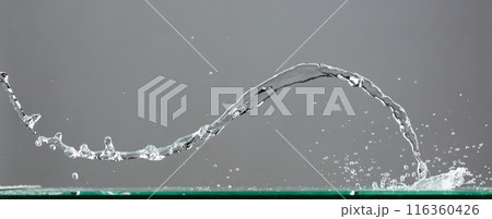 Crown Water splash on object to create shape form fluttering in droplet and wave. Crown water to object make curve drop explosion in ripple motion. Grey background isolated 116360426