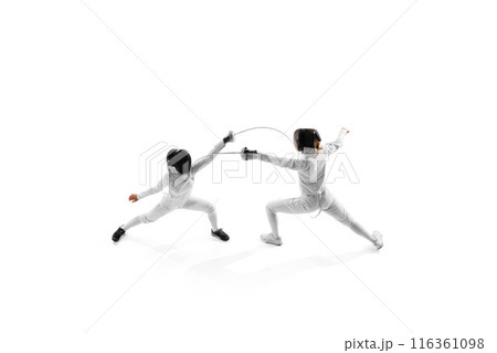 Aerial view of two female athletes practicing, during duel to improve their techniques in motion against white studio background. 116361098