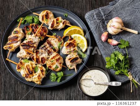grilled mini pork skewers on a plate, top view 116361237