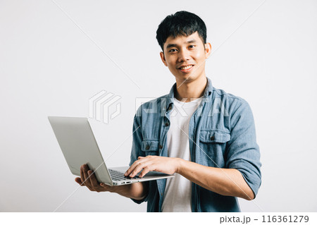 Portrait of a happy Asian student, excited and confident, using a laptop for email or chat. Studio shot isolated on white, showcasing his success in the online world. Portrait of a happy Asian student, excited and confident, using a laptop for email or chat. Studio shot isolated on white, showcasing his success in the online world. 116361279