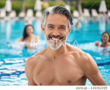 Happy Man Smiling in Swimming Pool: Summer Holiday Bliss 116362269