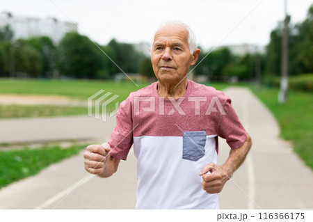 Elderly man with gray hair running in the park 116366175