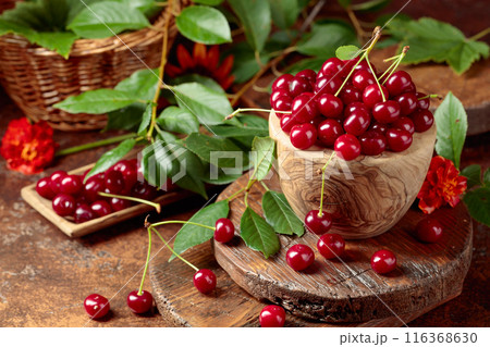 Ripe red cherries in a wooden dish. Ripe red cherries in a wooden dish. 116368630