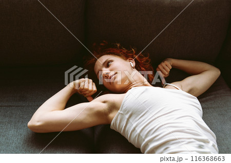 portrait muscular attractive young woman showing off muscles on arms 116368663
