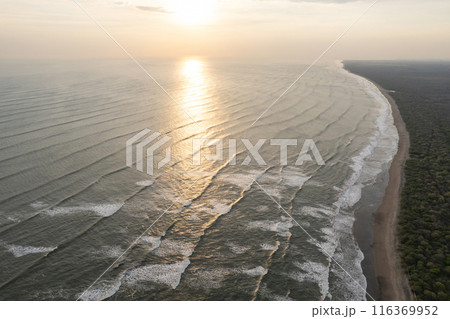 Reflection of sunset sun on ocean 116369952
