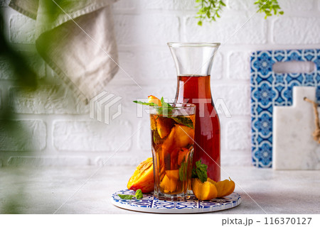 Cold ice tea with peach and mint 116370127