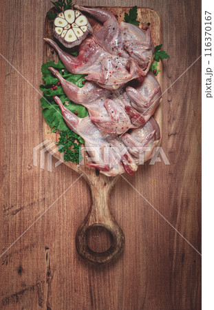 Raw quail meat, on a cutting board, with spices and herbs, top view, Raw quail meat, on a cutting board, with spices and herbs, top view, 116370167