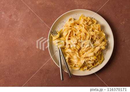 Fettuccine, tagliatelle, in creamy garlic sauce, Italian traditional cuisine, pasta carbonaro, 116370171