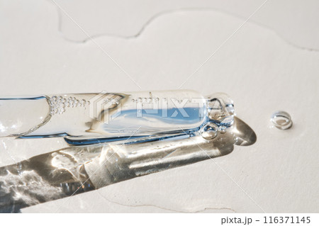 Pipette with serum on a beige background. Pipette with serum on a beige background. 116371145