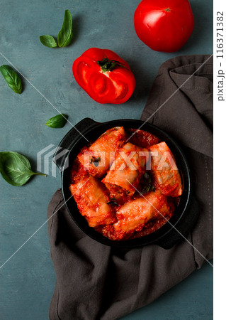 Stuffed cabbage rolls in tomato sauce, stuffed cabbage leaves, minced meat with rice, on a dark background, top view, no people, Stuffed cabbage rolls in tomato sauce, stuffed cabbage leaves, minced meat with rice, on a dark background, top view, no people, 116371382