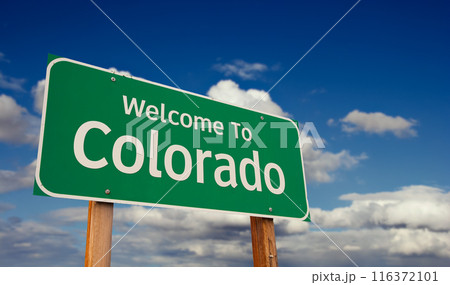 Welcome To Colorado Green Road Sign Over Blue Sky with Some Clouds. 116372101